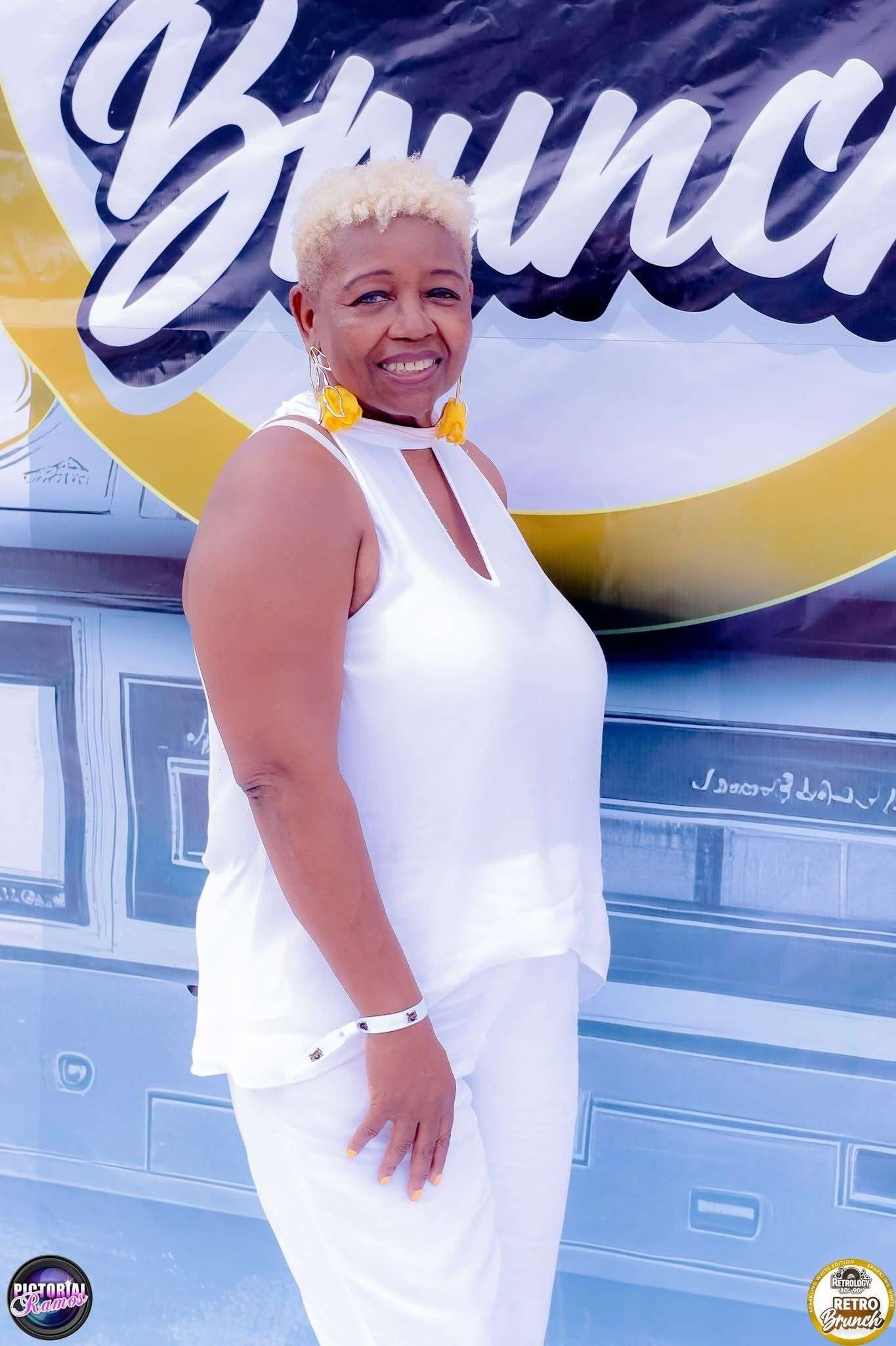 All-white portrait at branded wall